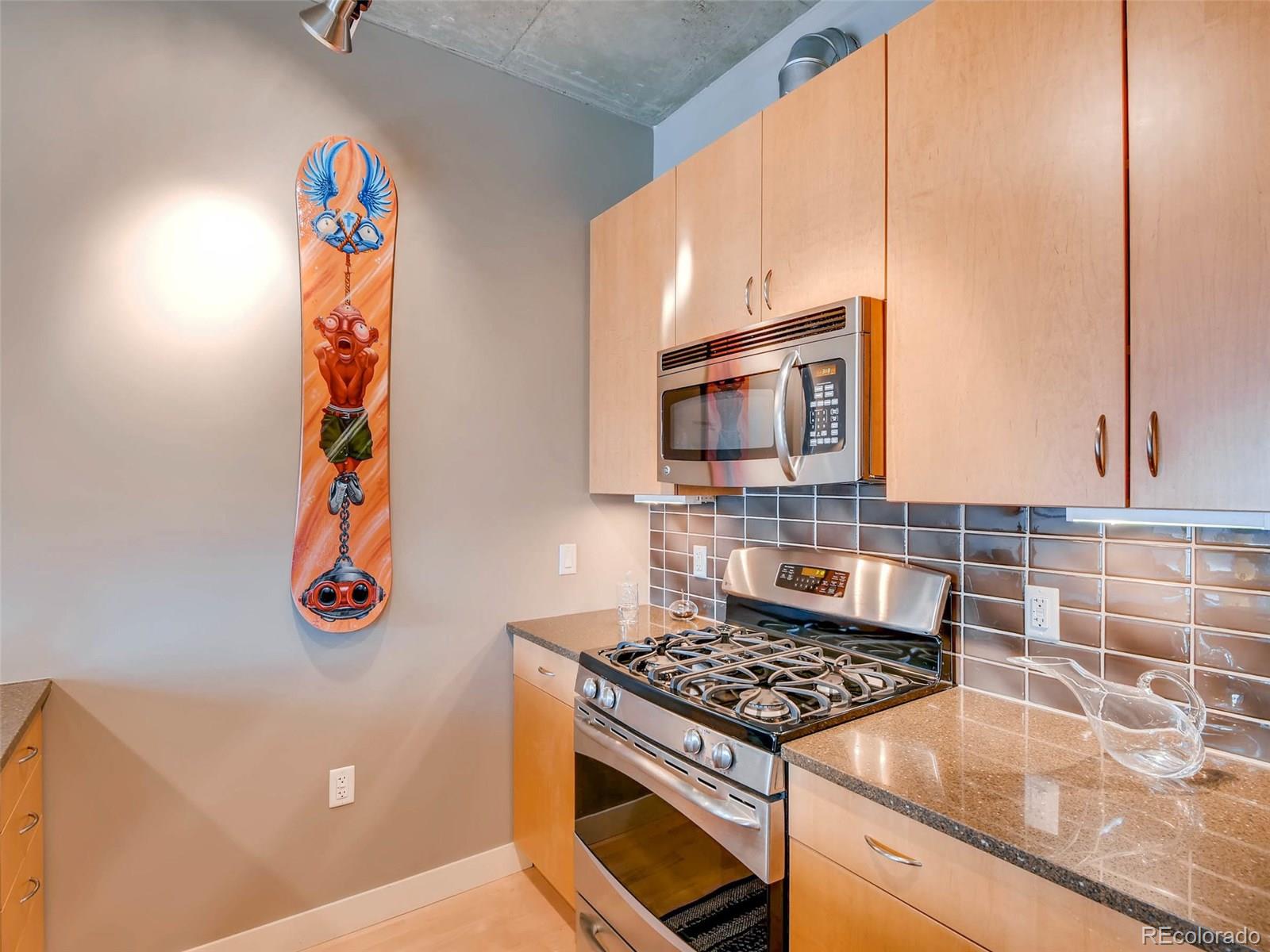 2229 Blake Street, Unit 506 Denver, CO 80205 - Photo 12 of 29 a kitchen with a stove and a microwave