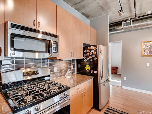 a kitchen with sink refrigerator and window