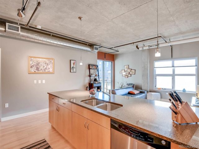 a kitchen with sink refrigerator and cabinets