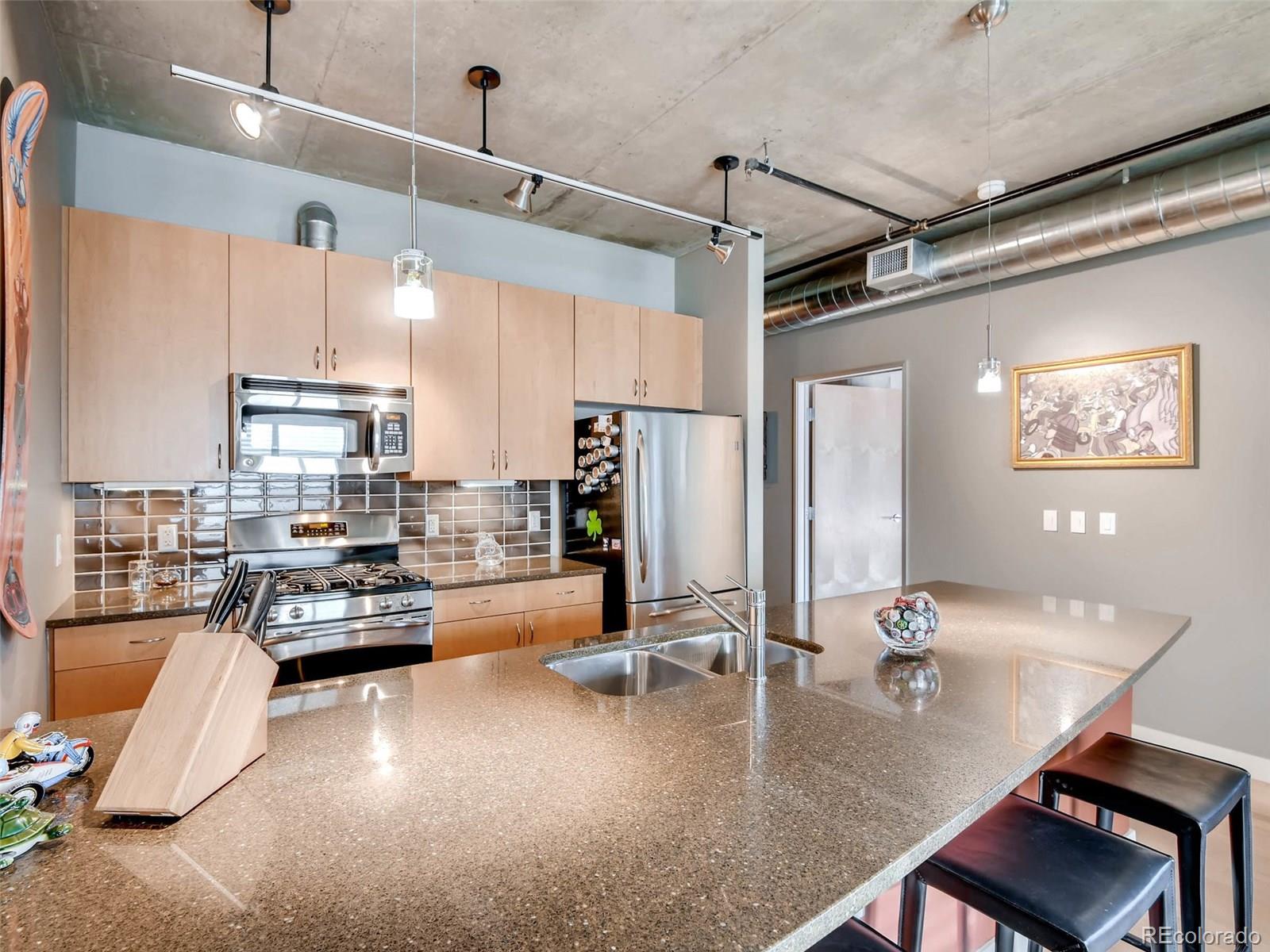 2229 Blake Street, Unit 506 Denver, CO 80205 - Photo 15 of 29 a kitchen with sink refrigerator and cabinets