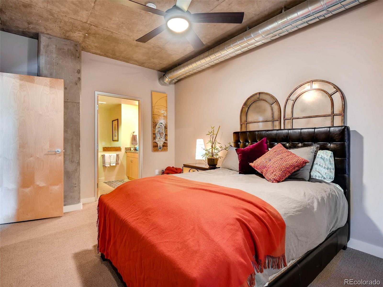 2229 Blake Street, Unit 506 Denver, CO 80205 - Photo 19 of 29 a bedroom with a bed and a painting on the wall