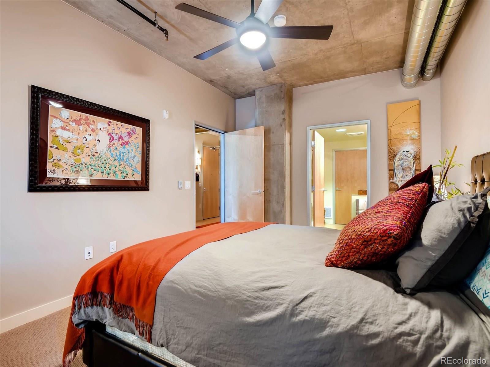 2229 Blake Street, Unit 506 Denver, CO 80205 - Photo 20 of 29 a bedroom with a bed and a chandelier