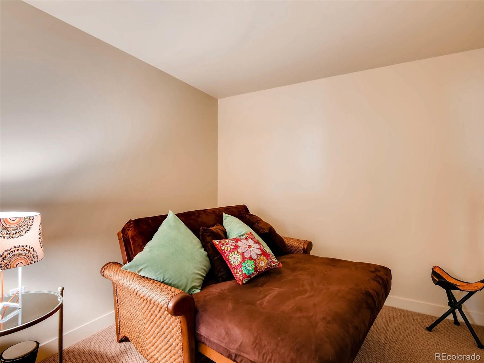 2229 Blake Street, Unit 506 Denver, CO 80205 - Photo 24 of 29 a bedroom with a bed and a couch