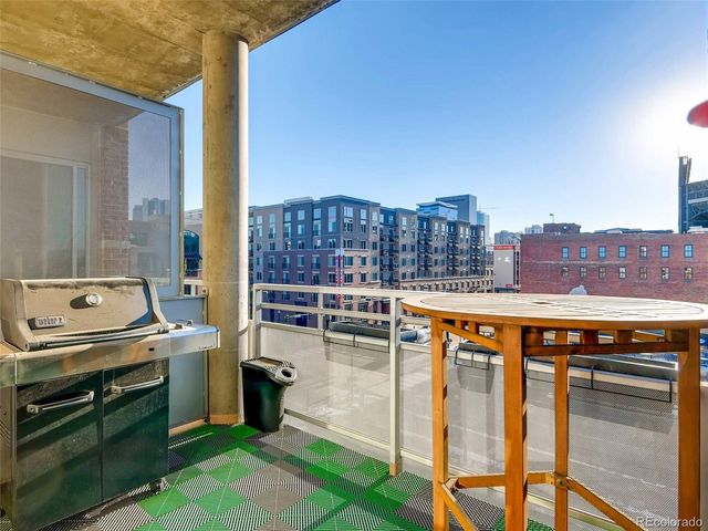 a balcony with a table and chairs