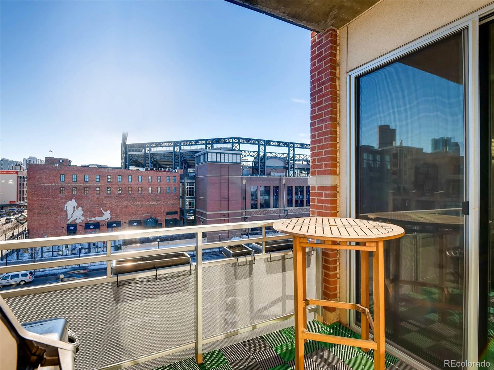 2229 Blake Street, Unit 506 Denver, CO 80205 - Photo 26 of 29 a balcony with a table and chairs