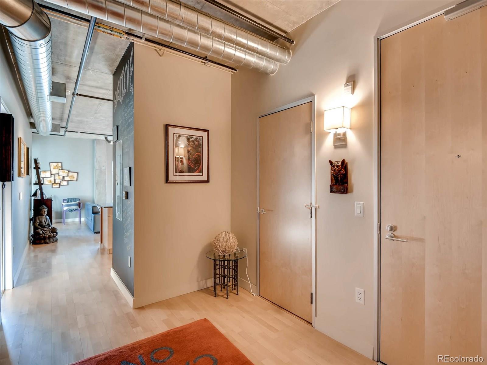 2229 Blake Street, Unit 506 Denver, CO 80205 - Photo 6 of 29 a view of a hallway with bathroom and wooden floor