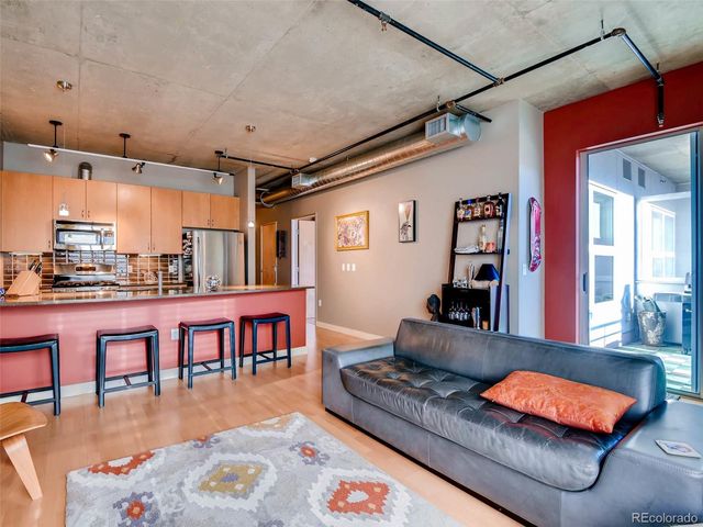 a living room with furniture pool table and a flat screen tv
