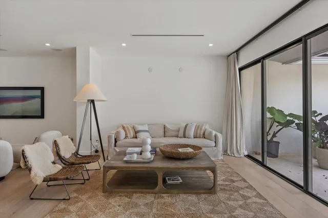 a kitchen with stainless steel appliances a table and chairs in it