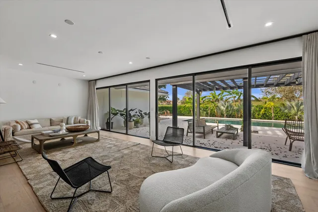 a view of kitchen with granite countertop a stove a sink a dining table and chairs