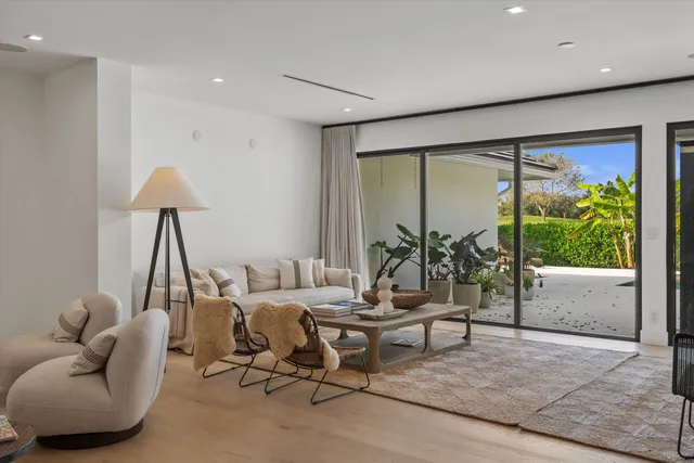 a kitchen with a table chairs refrigerator and microwave
