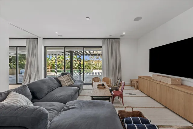 a bedroom with a bed window and a chair