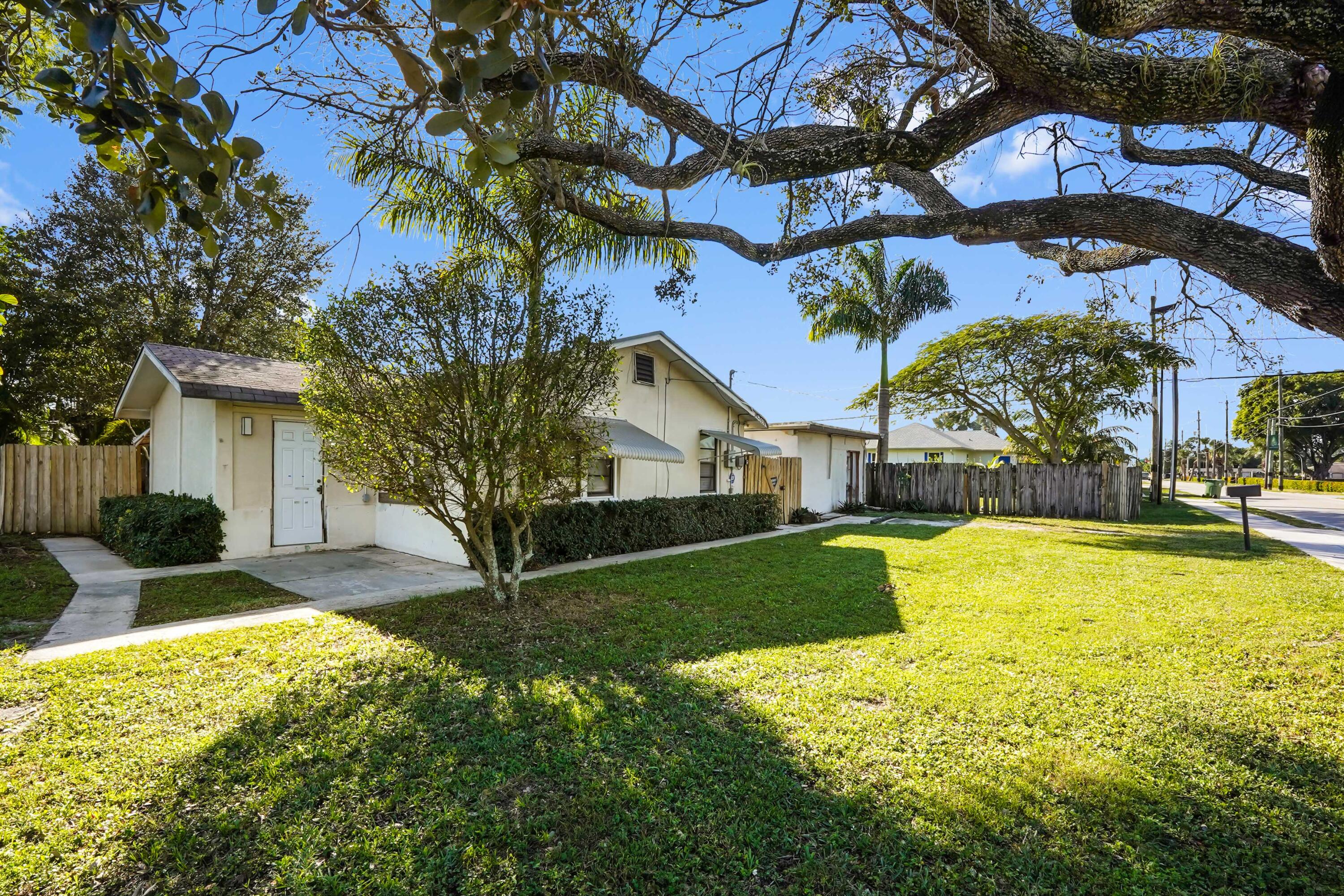 a house view with a swimming pool and garden