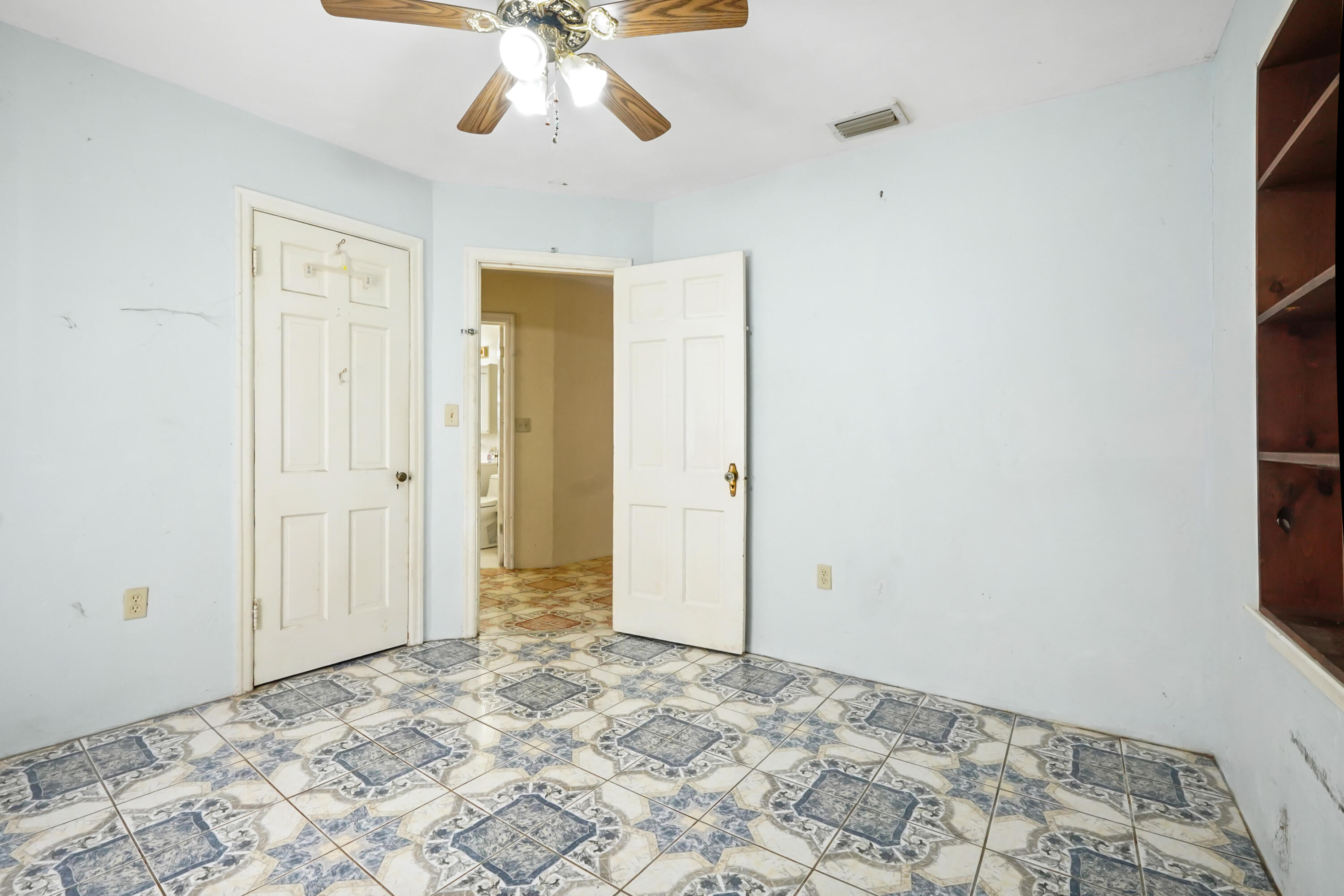 3858 Lakewood Road Palm Springs, FL 33461 - Photo 13 of 39 a view of a hallway with a chandelier fan