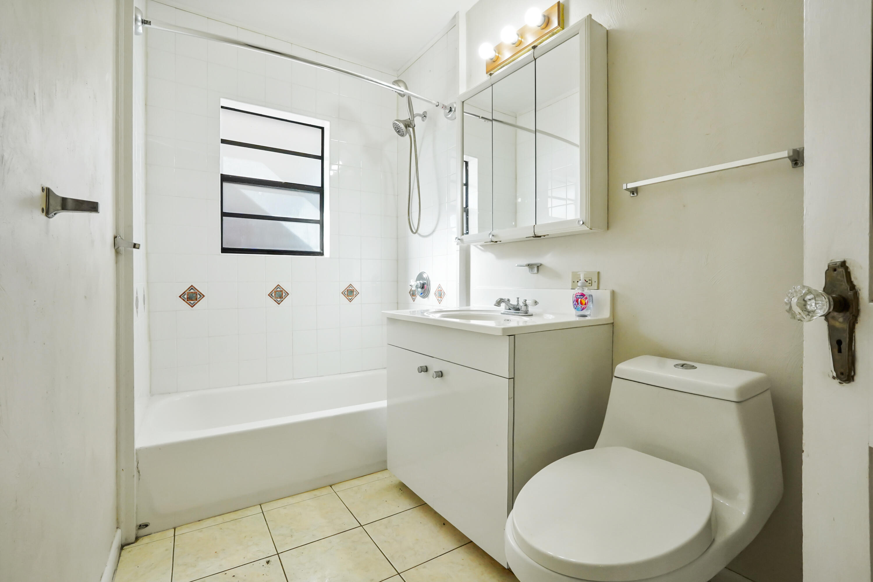 3858 Lakewood Road Palm Springs, FL 33461 - Photo 16 of 39 a bathroom with a toilet sink and bathtub