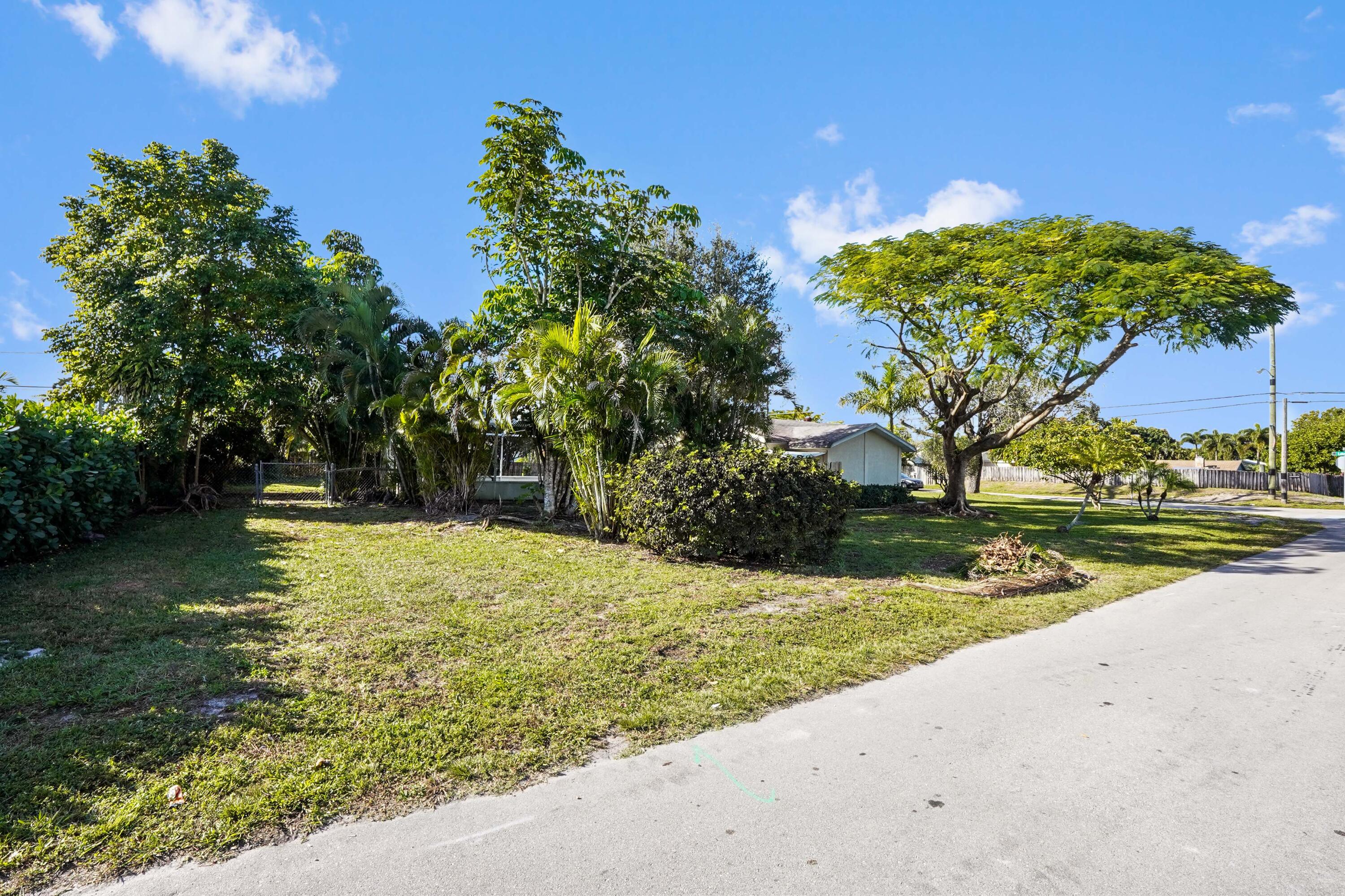 3858 Lakewood Road Palm Springs, FL 33461 - Photo 24 of 39 a view of a yard with an trees