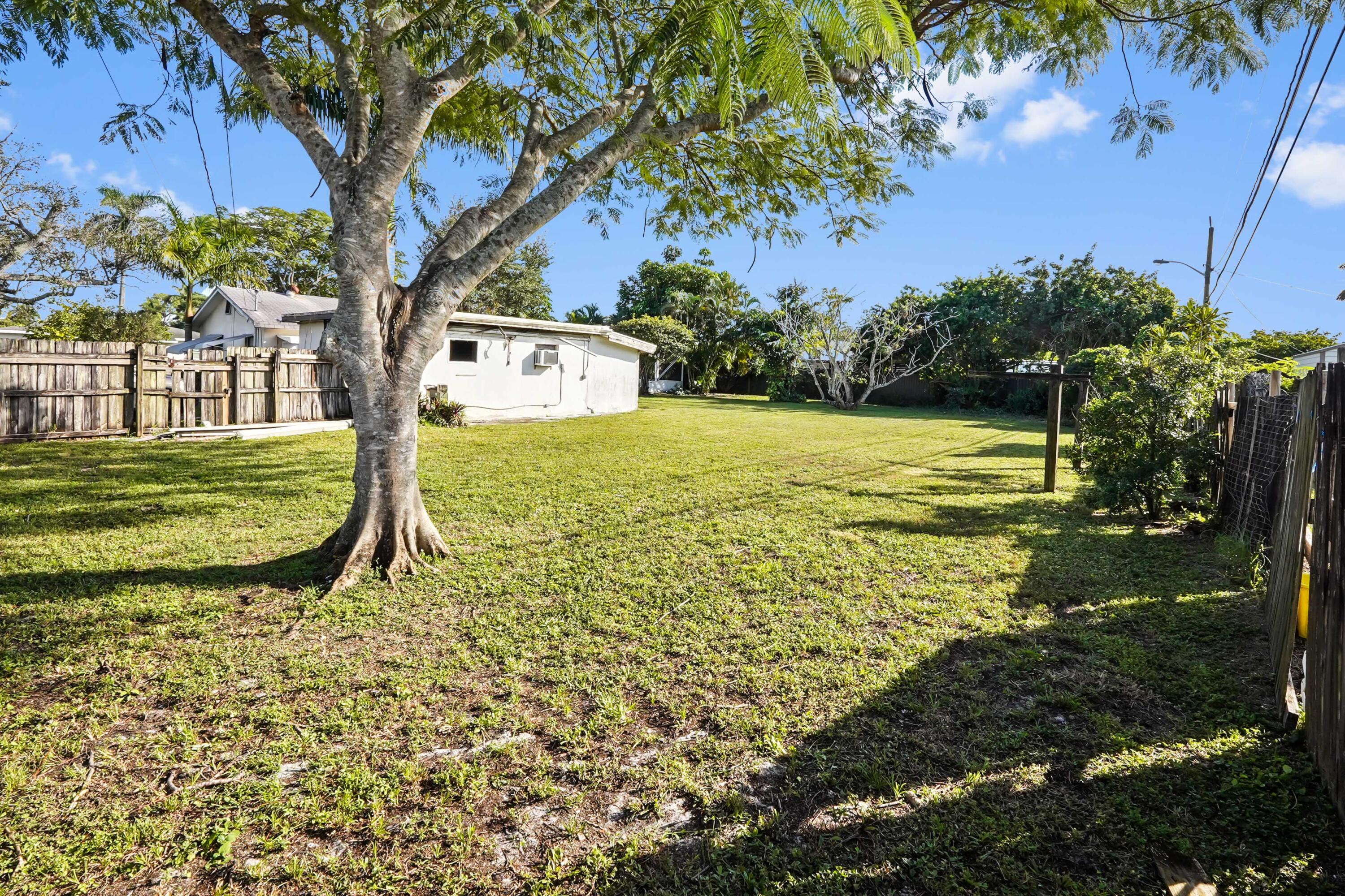 3858 Lakewood Road Palm Springs, FL 33461 - Photo 29 of 39 a view of a trees in front of a house