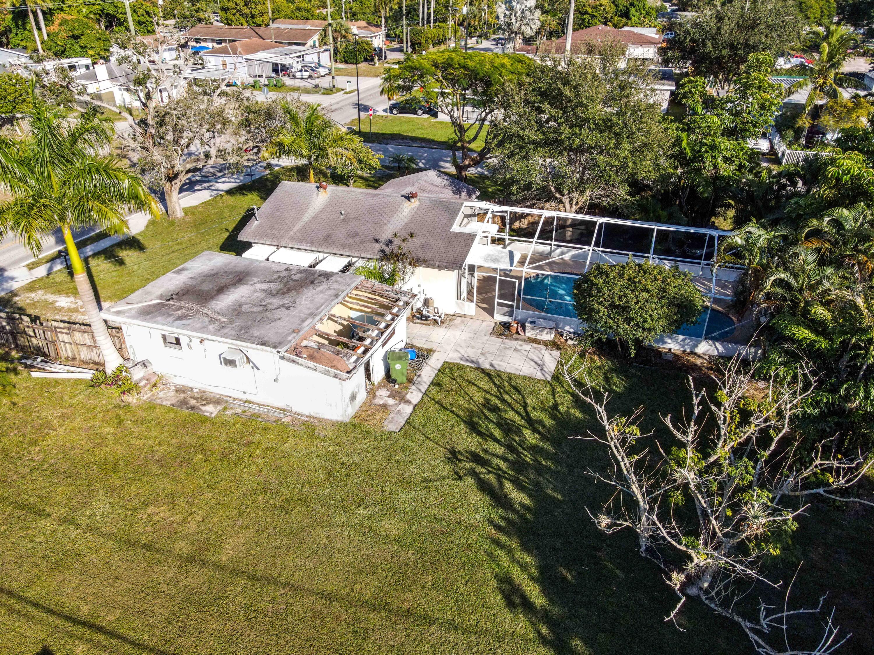 3858 Lakewood Road Palm Springs, FL 33461 - Photo 38 of 39 a view of a yard with plants and large trees