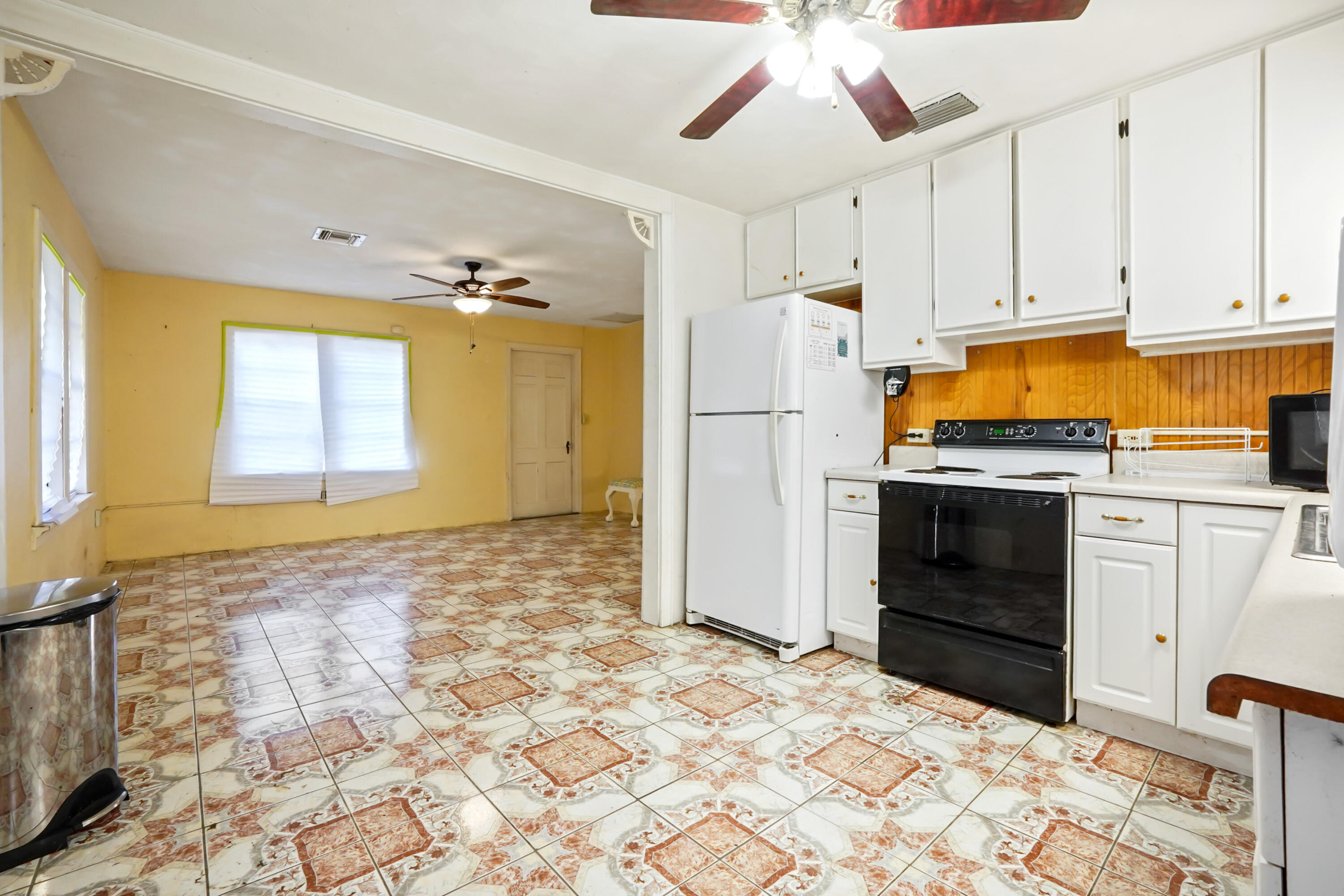 3858 Lakewood Road Palm Springs, FL 33461 - Photo 10 of 39 a kitchen with granite countertop a refrigerator and a stove top oven