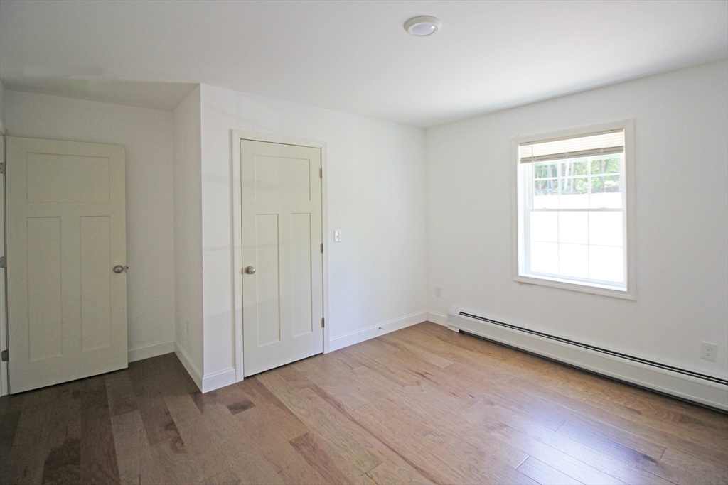 12 Pine Road Williamsburg, MA 01096 - Photo 13 of 24 an empty room with wooden floor and windows