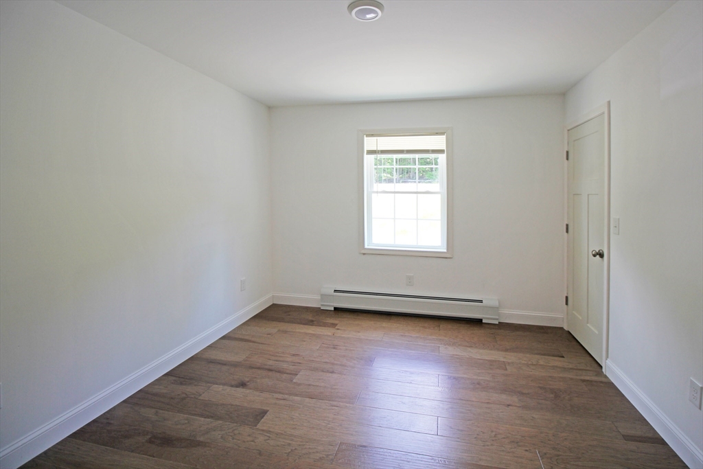 12 Pine Road Williamsburg, MA 01096 - Photo 15 of 24 an empty room with wooden floor and windows