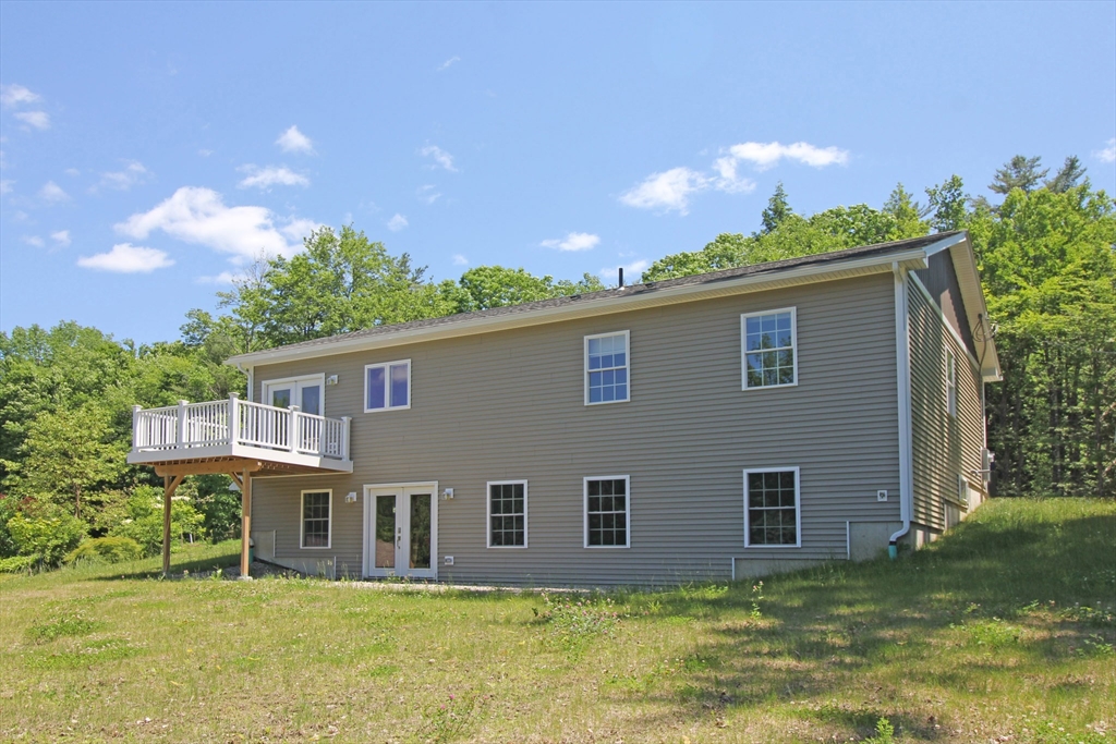 12 Pine Road Williamsburg, MA 01096 - Photo 21 of 24 a backyard of a house with table and chairs