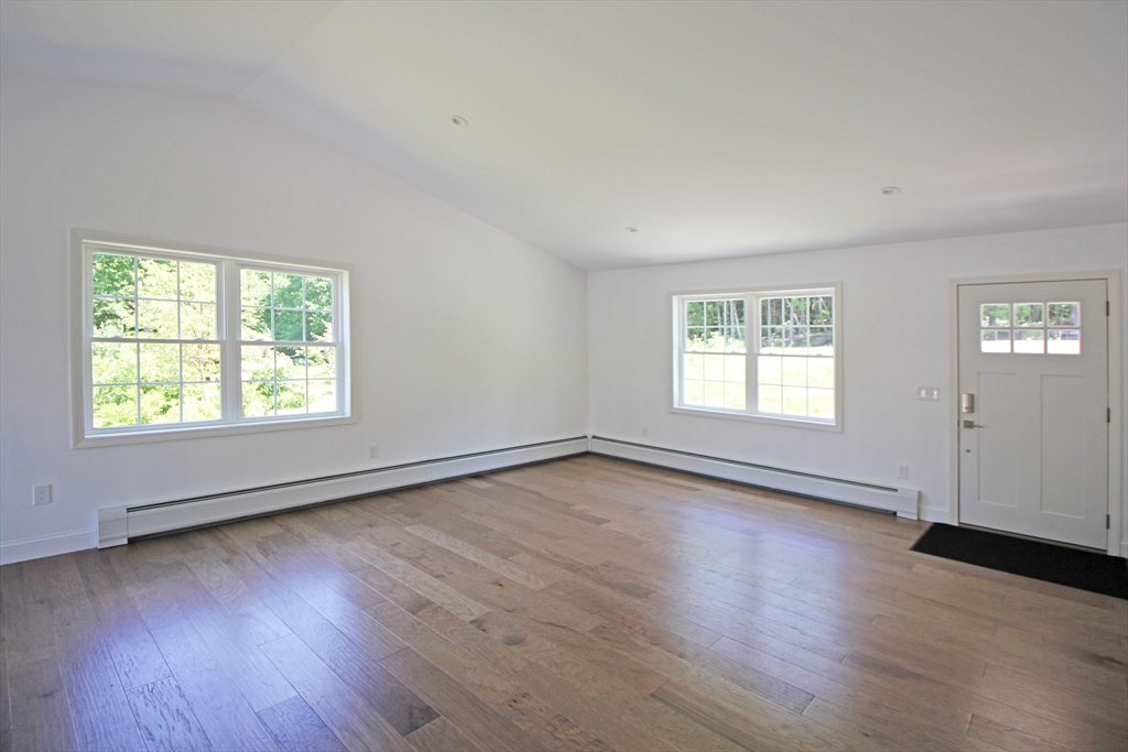 12 Pine Road Williamsburg, MA 01096 - Photo 6 of 24 an empty room with wooden floor and windows