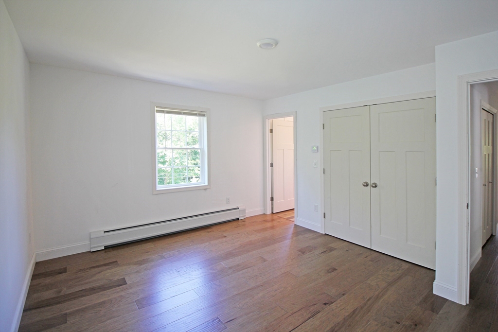 12 Pine Road Williamsburg, MA 01096 - Photo 9 of 24 a view of an empty room with wooden floor and a window