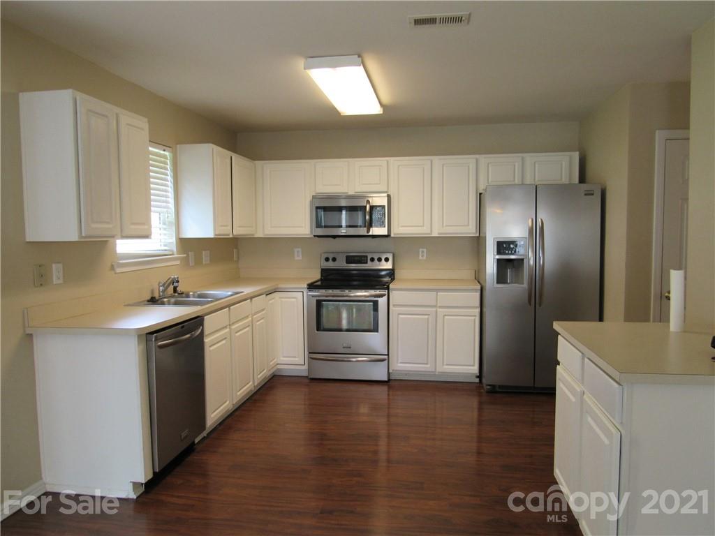 116 Royalton Road Mooresville, NC 28115 - Photo 4 of 12 a kitchen with a refrigerator stove top oven and sink