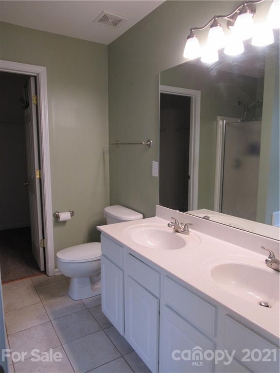 116 Royalton Road Mooresville, NC 28115 - Photo 7 of 12 a bathroom with a sink vanity granite toilet and a mirror
