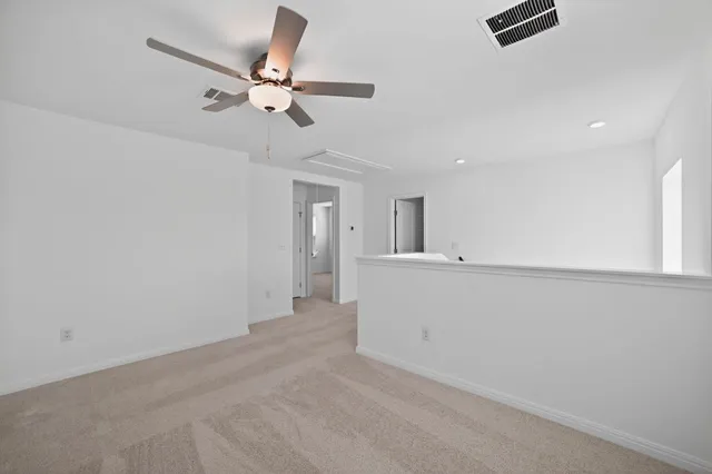 a view of room with window and ceiling fan