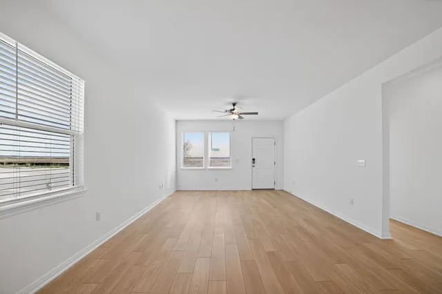 wooden floor in an empty room with a window