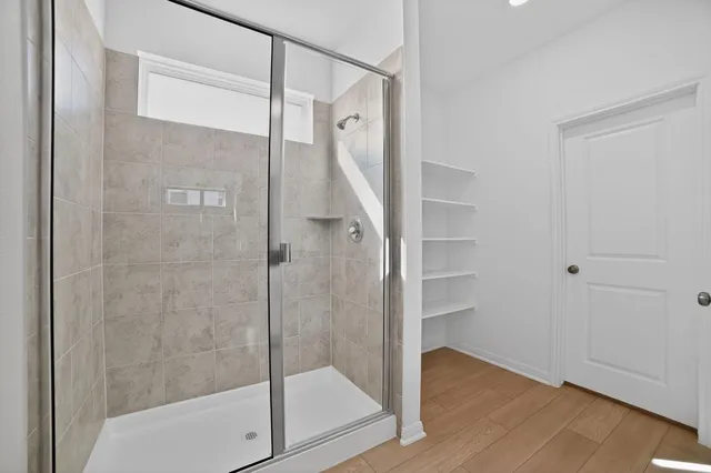 a bathroom with a glass shower door