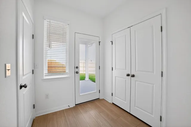 a view of a room with wooden floor and windows
