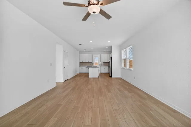 a view of a kitchen with a sink and cabinet with a living room