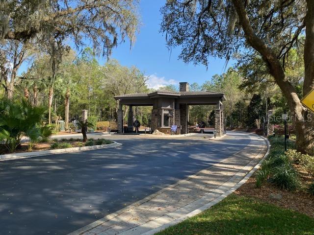 7625 Southwest 180th Circle Dunnellon, FL 34432 - Photo 15 of 21 a view of a swimming pool with a table and chairs under an umbrella