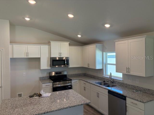 7625 Southwest 180th Circle Dunnellon, FL 34432 - Photo 6 of 21 a kitchen with granite countertop a sink a stove and cabinets