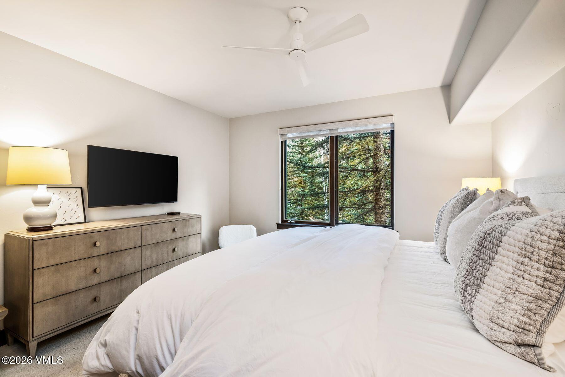30 Cresta Road, Unit 202 Edwards, CO 81632 - Photo 12 of 23 a bedroom with a bed and a flat screen tv