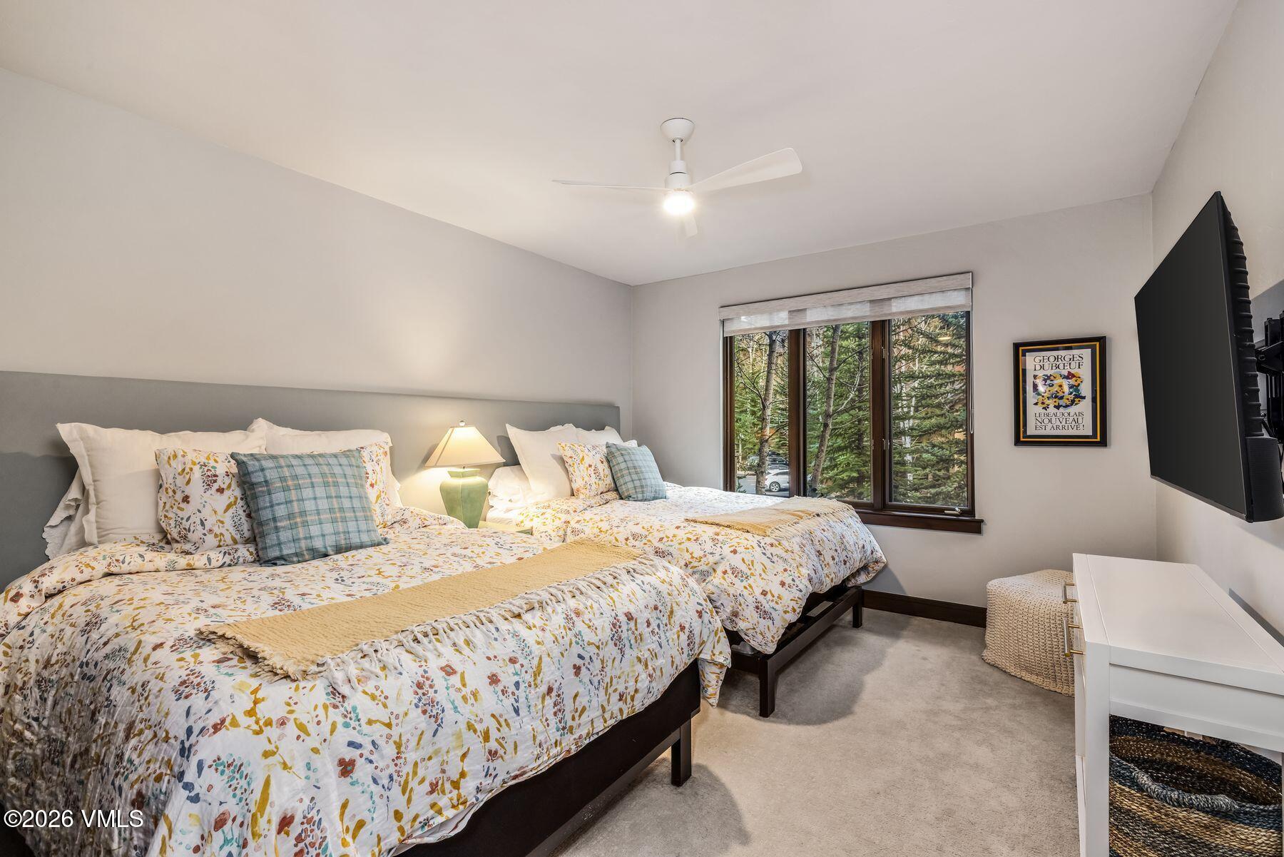 30 Cresta Road, Unit 202 Edwards, CO 81632 - Photo 15 of 23 a bedroom with a large bed and a tv