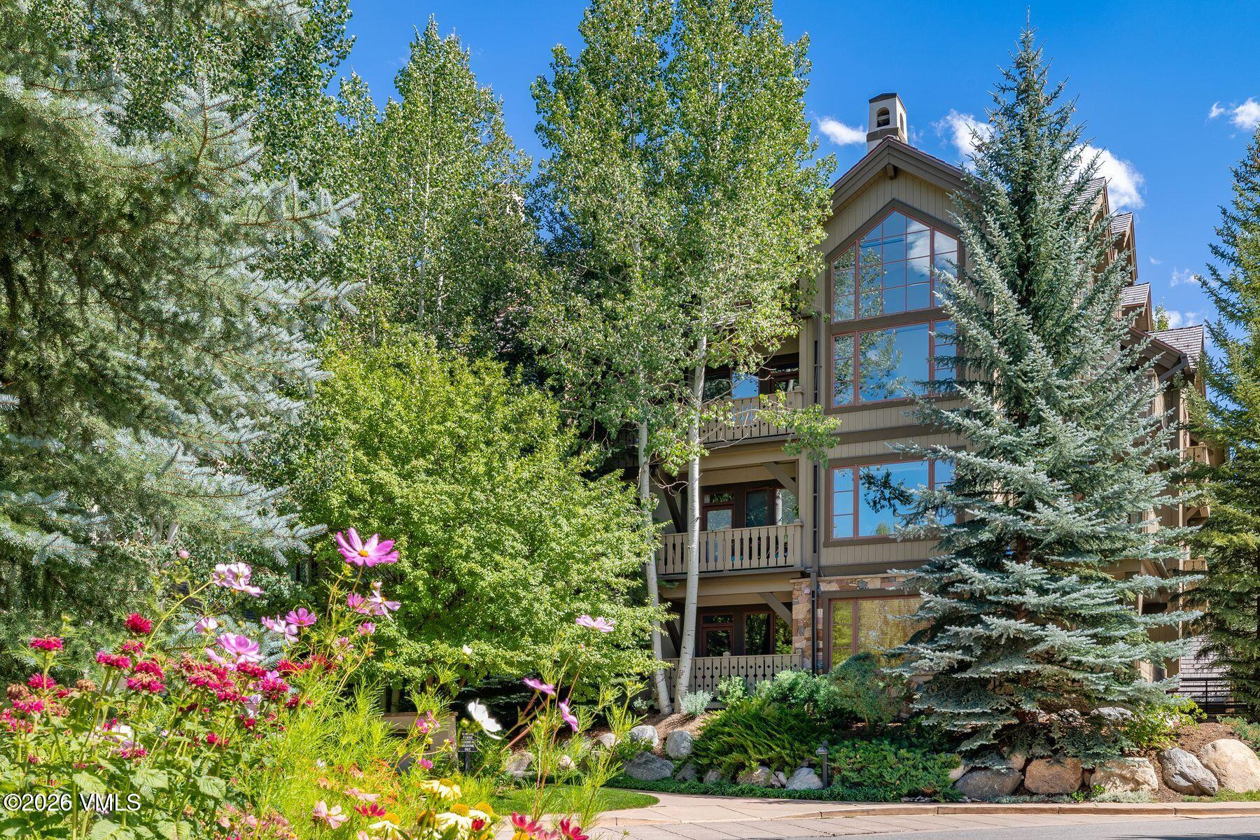 30 Cresta Road, Unit 202 Edwards, CO 81632 - Photo 20 of 23 a front view of a house with plants and trees