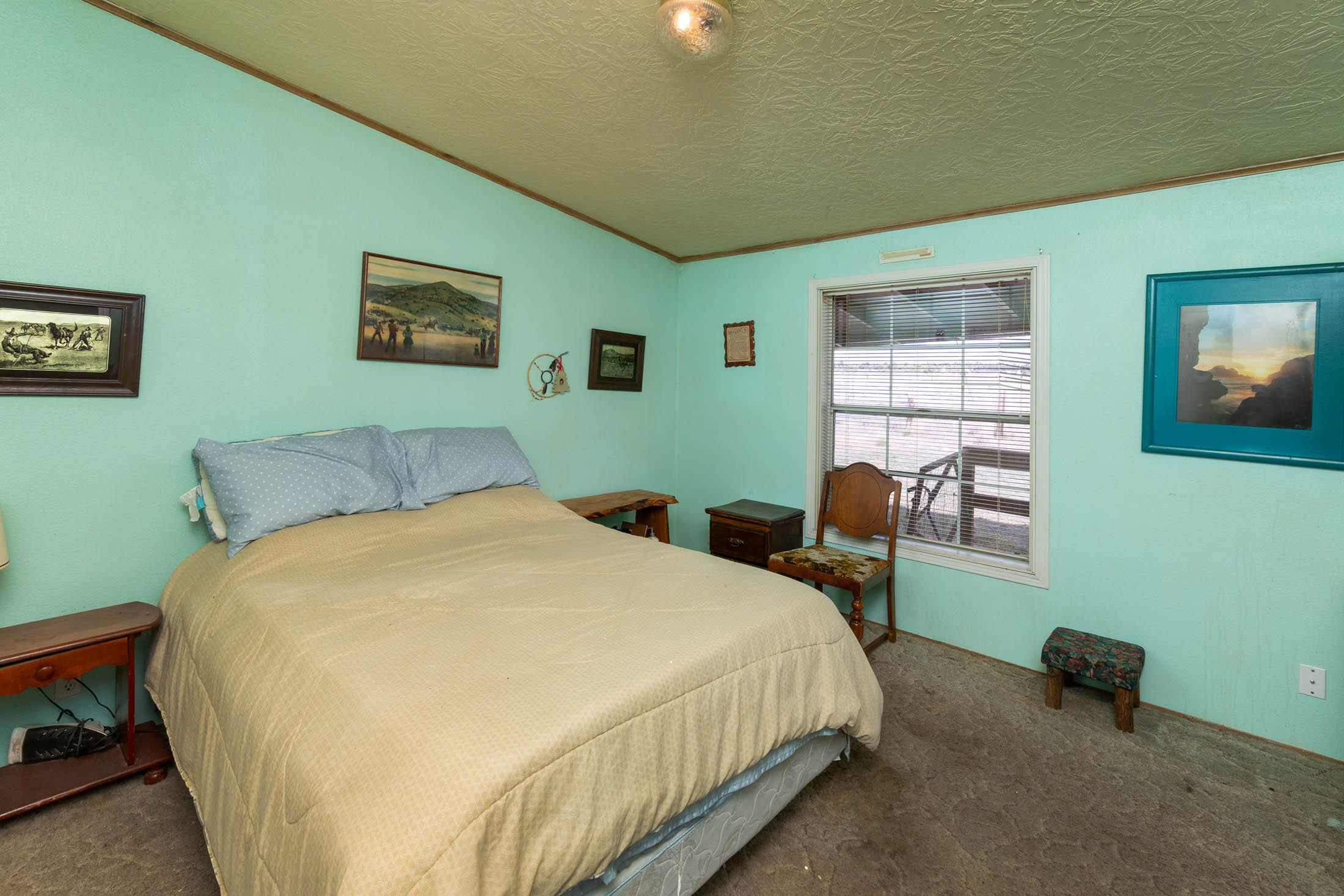 25907 South Cooper Street Bend, OR 97701 - Photo 17 of 34 a bedroom with a bed and a chair