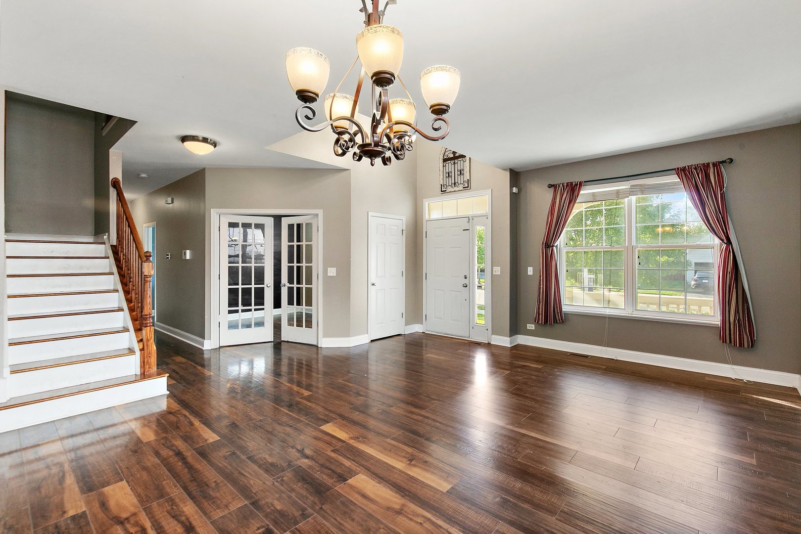 345 Shadow Hill Drive Elgin, IL 60124 - Photo 6 of 35 a view of an empty room with wooden floor and a window