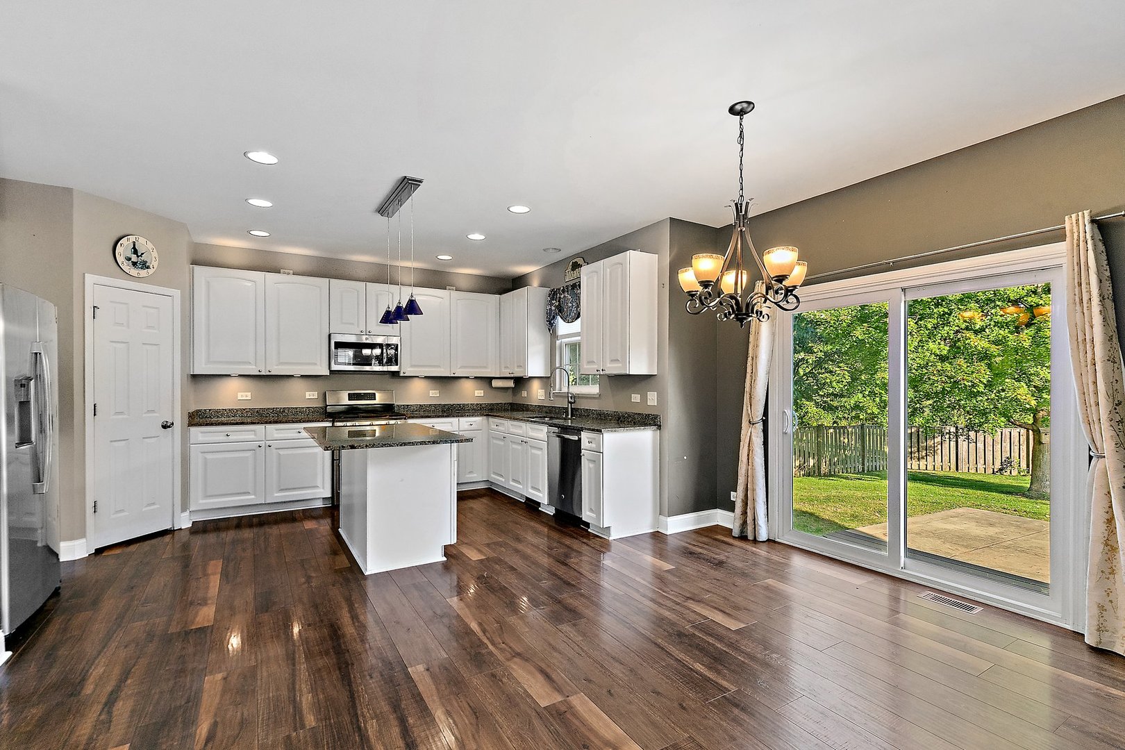 345 Shadow Hill Drive Elgin, IL 60124 - Photo 9 of 35 a open kitchen with stainless steel appliances granite countertop a refrigerator a oven and a wooden floors