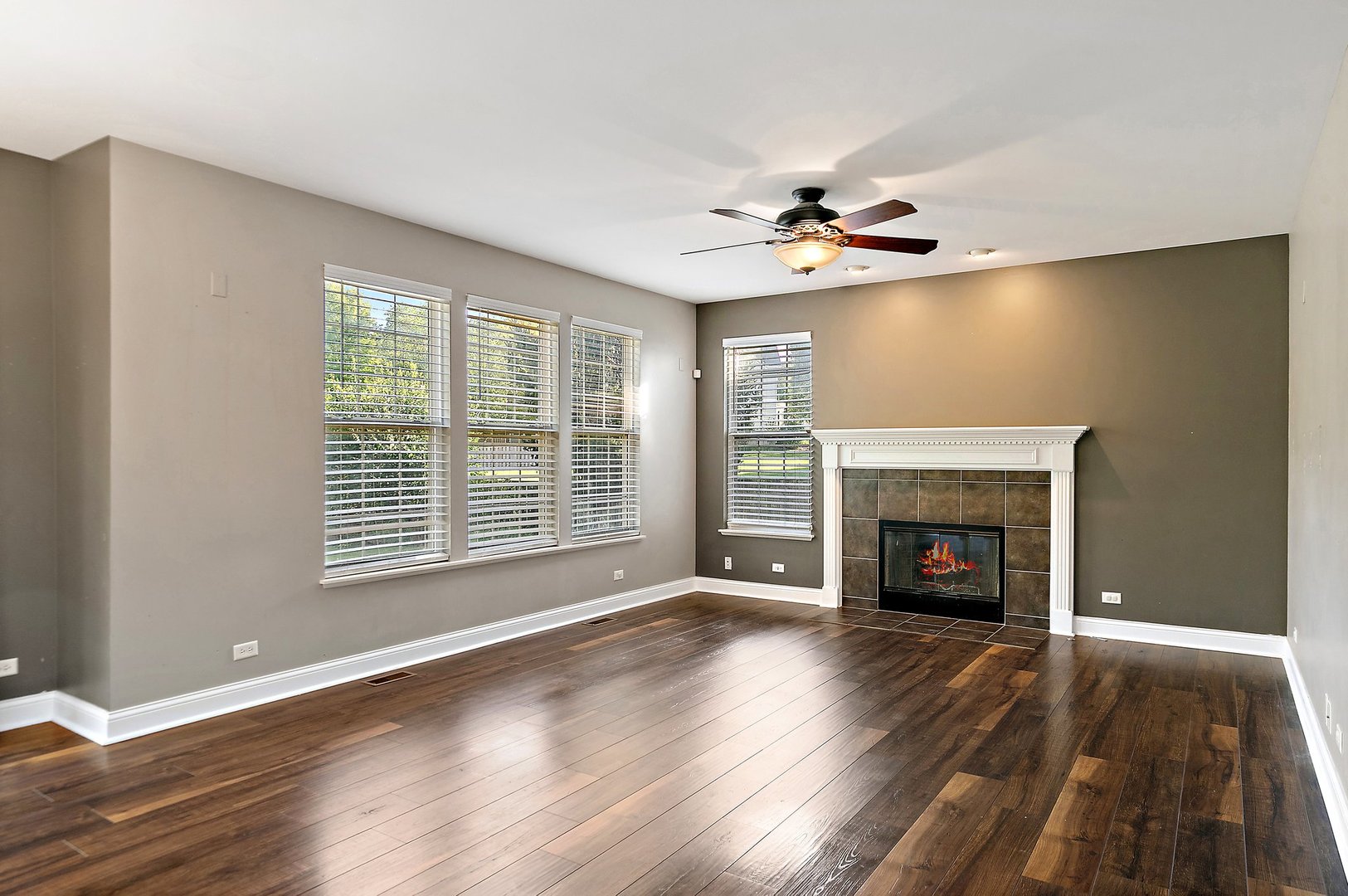 345 Shadow Hill Drive Elgin, IL 60124 - Photo 10 of 35 wooden floor fireplace and windows in an empty room