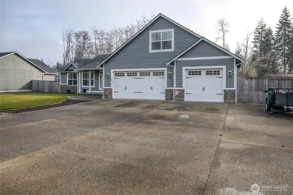 a view of a house with a yard and garage
