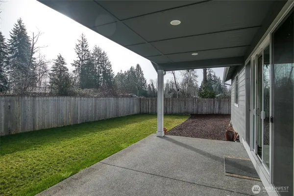 a view of yard with patio