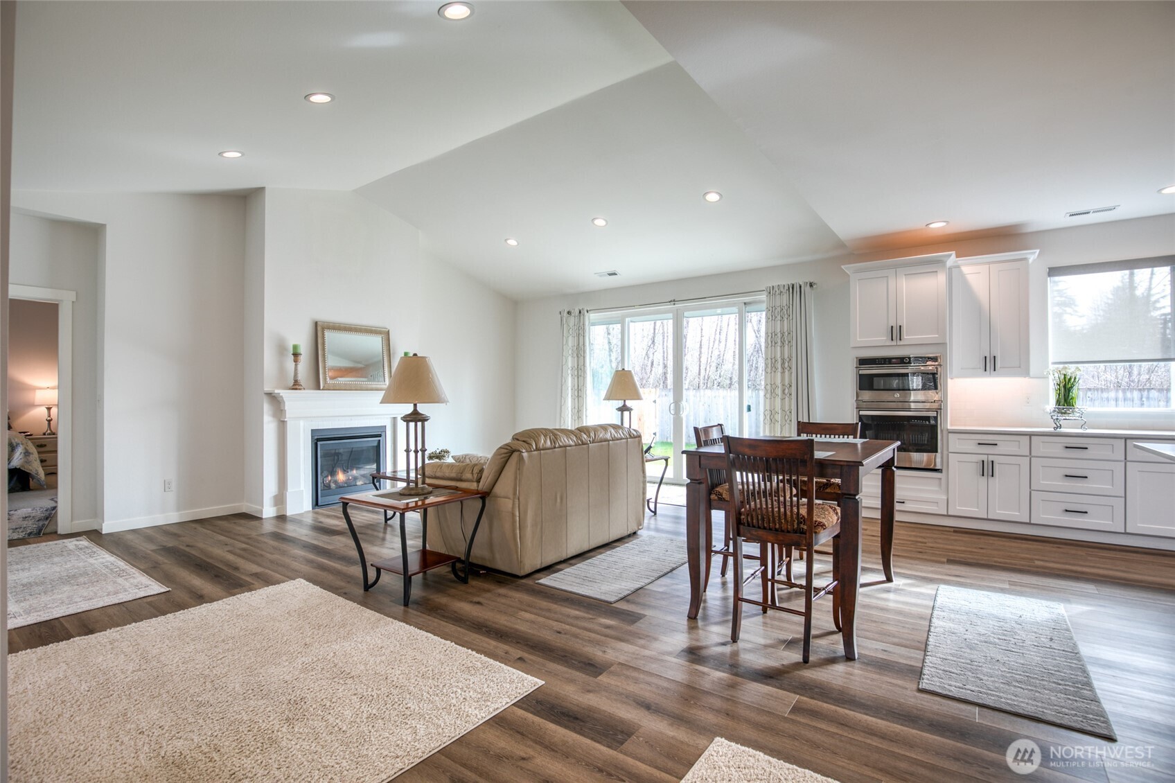 28 Roup Road Montesano, WA 98563 - Photo 6 of 40 a living room with furniture a dining table and kitchen view with wooden floor