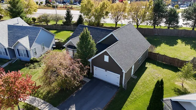a view of house with garden space and sitting area