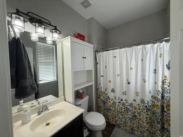 a bathroom with a sink toilet and shower