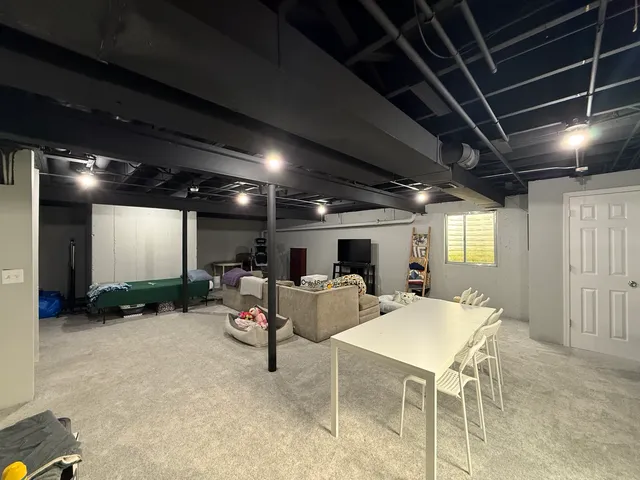 a living room with lots of furniture and a projector