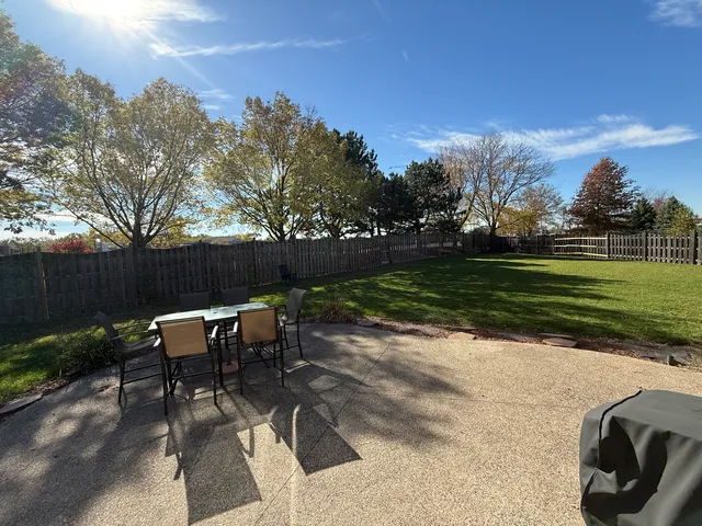 a view of a backyard with sitting area